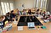 Picture of a seminar room with students reading or working on their laptops.