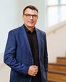 Portrait of a man in front of a staircase