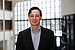 A young man, portrait photo Prof. Dr. Lukas Stötzer, with dark hair and glasses smiles friendly into the camera.