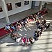 Bird's eye view of a group of people sitting in a circle on the floor.