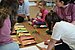 Children and students sit in a circle on the floor and look at cards with bears in different moods.