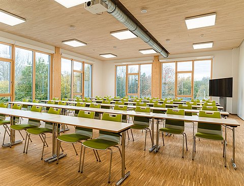 Photo of a seminar room with rows of tables and chairs