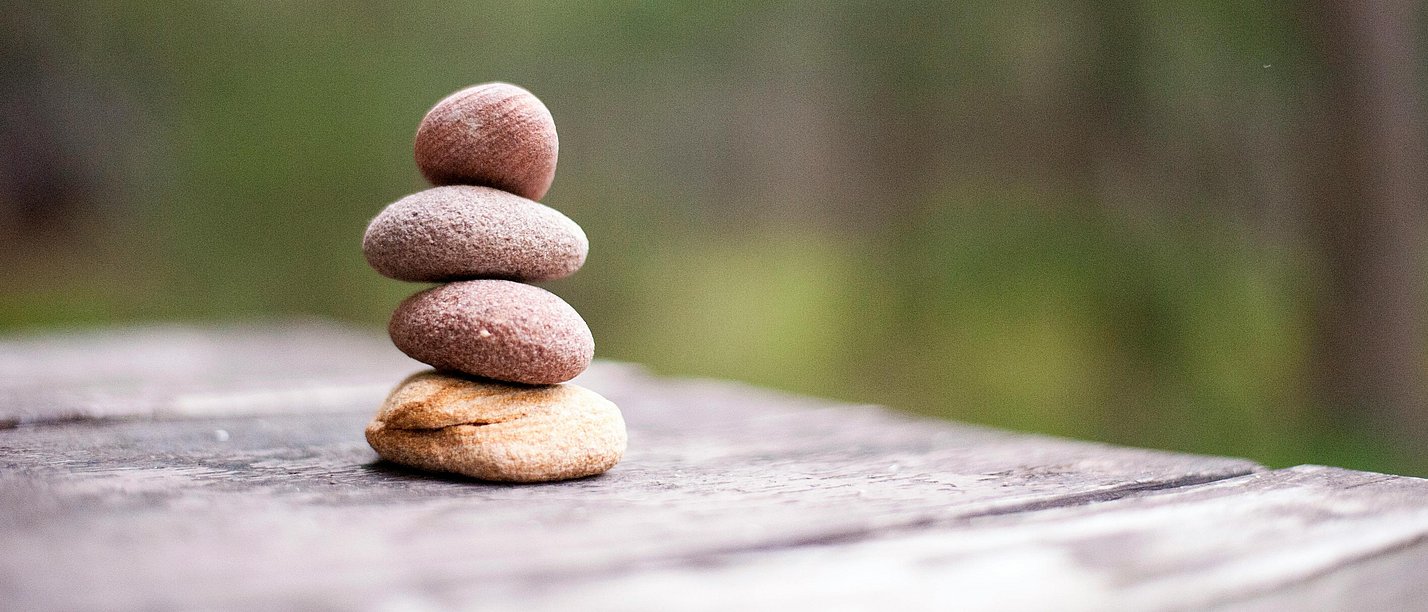 Four small stones stacked on top of each other.