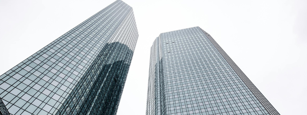 Frog's-eye view of the window fronts of two tower blocks